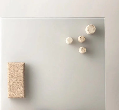 Cork magnetic eraser on whiteboard with cork magnets