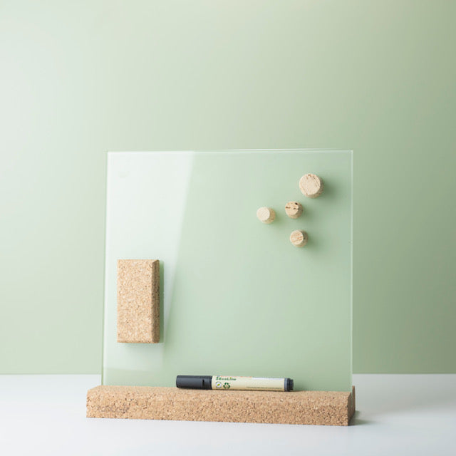 Cork eraser and cork magnets on small glass whiteboard